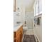 Clean bathroom with shower stall, wood vanity, and neutral colors at 7447 Quay St, Arvada, CO 80003