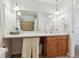 Bathroom with wood vanity, mirror, and neutral colors at 7447 Quay St, Arvada, CO 80003