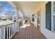 Inviting front porch with wooden deck and railings at 7447 Quay St, Arvada, CO 80003