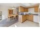 Galley kitchen with light wood cabinets and appliances at 7447 Quay St, Arvada, CO 80003