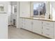 White kitchen cabinets and countertops with backyard view at 7447 Quay St, Arvada, CO 80003