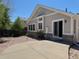 Backyard featuring a concrete patio, rock cover, and an exterior view of the home at 20148 E Dartmouth Dr, Aurora, CO 80013