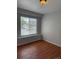 Bedroom with hardwood floors and a large window with blinds at 20148 E Dartmouth Dr, Aurora, CO 80013