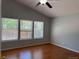 Bright bedroom featuring hardwood floors, vaulted ceilings, and large windows at 20148 E Dartmouth Dr, Aurora, CO 80013