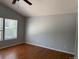 Bedroom featuring hardwood floors and large windows at 20148 E Dartmouth Dr, Aurora, CO 80013