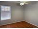 Bedroom featuring hardwood floors, a ceiling fan, and a large window at 20148 E Dartmouth Dr, Aurora, CO 80013