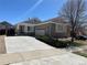 Inviting single-story home with a spacious driveway, attached garage, and neatly landscaped front yard at 20148 E Dartmouth Dr, Aurora, CO 80013