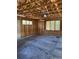 A spacious garage with wood walls, concrete floors, and windows at 20148 E Dartmouth Dr, Aurora, CO 80013