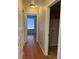 Hallway with wood floors leading to bedroom, and laundry room at 20148 E Dartmouth Dr, Aurora, CO 80013