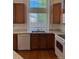 Functional kitchen space showcasing wood cabinets, white appliances, and a bright window over the sink at 20148 E Dartmouth Dr, Aurora, CO 80013