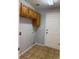 Laundry room with tile flooring and overhead cabinets at 20148 E Dartmouth Dr, Aurora, CO 80013