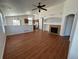 Spacious living room featuring hardwood floors, a cozy fireplace, and an open layout that flows into the kitchen at 20148 E Dartmouth Dr, Aurora, CO 80013