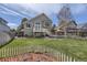 Spacious backyard featuring a manicured lawn, a picket fence, a deck, and access to the home's second story at 9724 Iris St, Broomfield, CO 80021