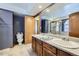 Bathroom featuring dual sinks, a large mirror, and ample counter space at 9724 Iris St, Broomfield, CO 80021