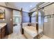 Bathroom featuring a shower stall, bathtub, and a view into the main bedroom at 9724 Iris St, Broomfield, CO 80021