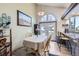 Dining area with light-colored furniture, complemented by natural light and stylish decor at 9724 Iris St, Broomfield, CO 80021