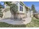 Side of home featuring brick accents, greenery, and steps leading to the front door at 9724 Iris St, Broomfield, CO 80021