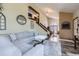 Spacious living room with a fireplace, staircase, and open layout to the dining area at 9724 Iris St, Broomfield, CO 80021