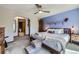 Comfortable main bedroom featuring a ceiling fan, a walk-in closet, and access to an en-suite bathroom at 9724 Iris St, Broomfield, CO 80021
