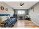 Cozy bedroom featuring wood floors, neutral walls and a ceiling fan at 6075 W Jefferson Ave, Denver, CO 80235