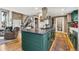 Open concept kitchen featuring a center island with sleek countertops and hardwood floors throughout at 6075 W Jefferson Ave, Denver, CO 80235