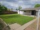 Expansive backyard with a large, well-kept lawn and a covered patio, ideal for outdoor enjoyment at 3905 Nelson St, Wheat Ridge, CO 80033