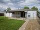 Spacious backyard featuring a covered patio area with a well-maintained lawn and mature trees at 3905 Nelson St, Wheat Ridge, CO 80033