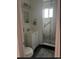 Bathroom with shower and glass door featuring a white vanity, framed mirror, and gray tile floor at 3905 Nelson St, Wheat Ridge, CO 80033