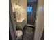 Compact bathroom featuring a shower with glass door, updated vanity, and matching toilet at 3905 Nelson St, Wheat Ridge, CO 80033