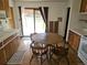 Eat-in kitchen with dining table and chairs next to sliding door with backyard view at 3905 Nelson St, Wheat Ridge, CO 80033