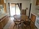 Eat-in kitchen has sliders to the deck, wood cabinets, and tile flooring at 3905 Nelson St, Wheat Ridge, CO 80033
