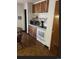 Eat-in kitchen has wood cabinets and open shelving at 3905 Nelson St, Wheat Ridge, CO 80033