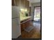 Eat-in kitchen has updated sink, wood cabinets, and sliding door to the outside at 3905 Nelson St, Wheat Ridge, CO 80033