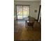 A cozy kitchen boasts natural light, a round table and chair, and access to the backyard at 3905 Nelson St, Wheat Ridge, CO 80033