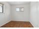 A well-lit bedroom with hardwood floors, a window and closet space at 7600 Monaco St, Commerce City, CO 80022