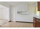 Bright eat-in kitchen area with white pantry cabinets and adjoining rooms at 7600 Monaco St, Commerce City, CO 80022