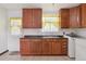 Bright kitchen with wood cabinets, and an adjacent laundry area at 7600 Monaco St, Commerce City, CO 80022