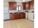 A kitchen showcasing ample counter space with wood cabinets and updated appliances, plus exterior door at 7600 Monaco St, Commerce City, CO 80022