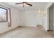 Living room with carpet, ceiling fan, and window at 7600 Monaco St, Commerce City, CO 80022