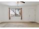 Living room with carpet, ceiling fan, and window at 7600 Monaco St, Commerce City, CO 80022