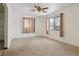 Living room with carpet, ceiling fan, and window at 7600 Monaco St, Commerce City, CO 80022