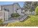 Backyard with patio, white picket fence, mature trees, and garden features at 2265 S Depew St, Denver, CO 80227