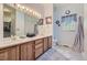 Bathroom featuring double sinks, lots of counter space, and tile floors for a clean, modern look at 2265 S Depew St, Denver, CO 80227