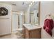 Bright bathroom featuring a glass enclosed shower, vanity with sink, and decorative wreath at 2265 S Depew St, Denver, CO 80227