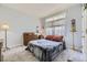 Comfortable bedroom with soft carpet, dresser, and natural lighting from a window at 2265 S Depew St, Denver, CO 80227