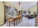 Bright dining room featuring a large window and a view into the living room at 2265 S Depew St, Denver, CO 80227