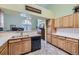 Functional kitchen with wood cabinets and modern appliances open to living space at 2265 S Depew St, Denver, CO 80227