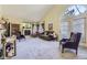 Inviting living room with vaulted ceilings, a cozy fireplace, and abundant natural light from large windows at 2265 S Depew St, Denver, CO 80227