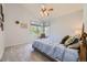 Serene main bedroom with plush carpeting, a ceiling fan, and a large window providing natural light at 2265 S Depew St, Denver, CO 80227