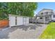 View of the shed and deck with stairs in the gravel backyard at 12366 Elm Way, Thornton, CO 80241